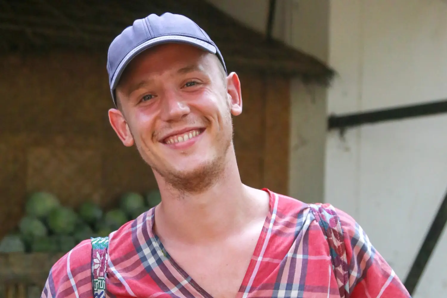 Picture showing the author of the blog, Markus Dotzler, a white man wearing a blue baseball cap and a red shirt smiling