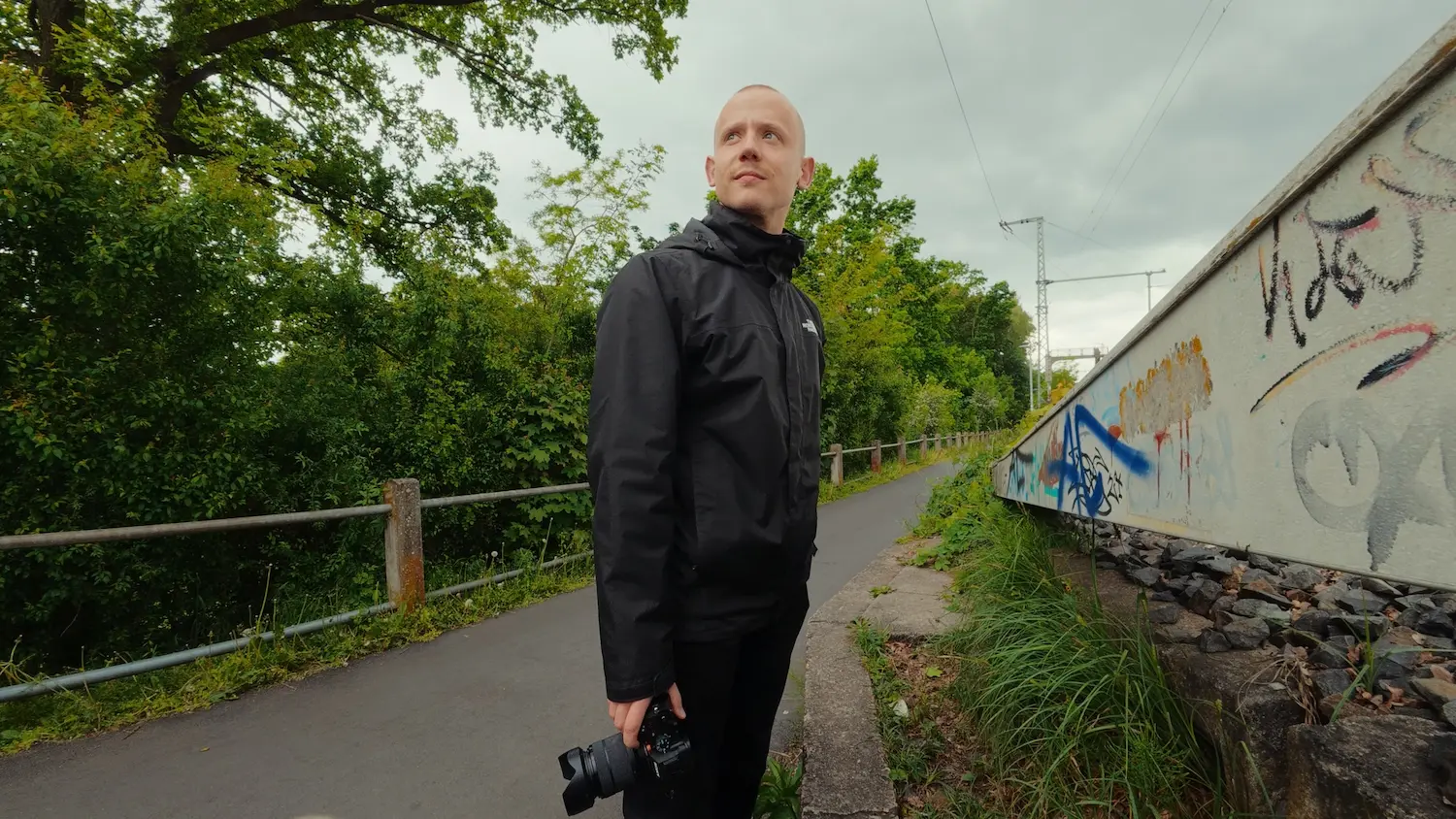 Markus Dotzler, the owner of www.markusdotzler.de, wearing a black jacket and carrying a camera